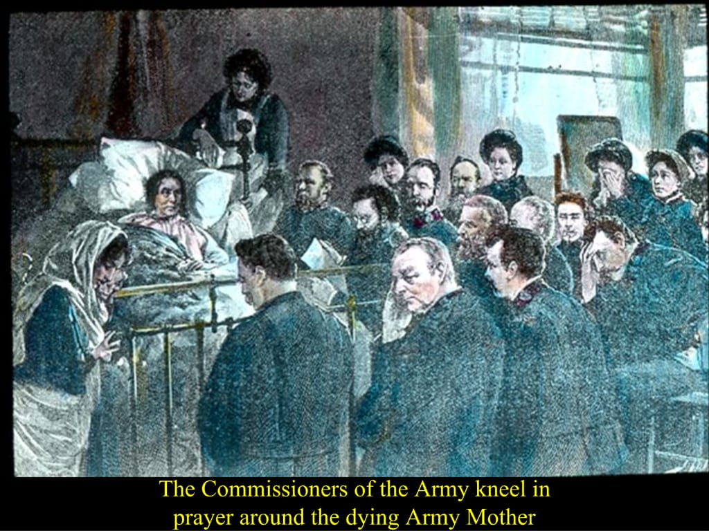 The Commissioners of the Army kneel in. prayer around the dying Army Mother.